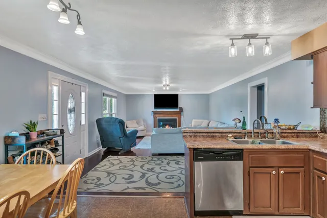 a view of a kitchen with kitchen island a dining table and chairs