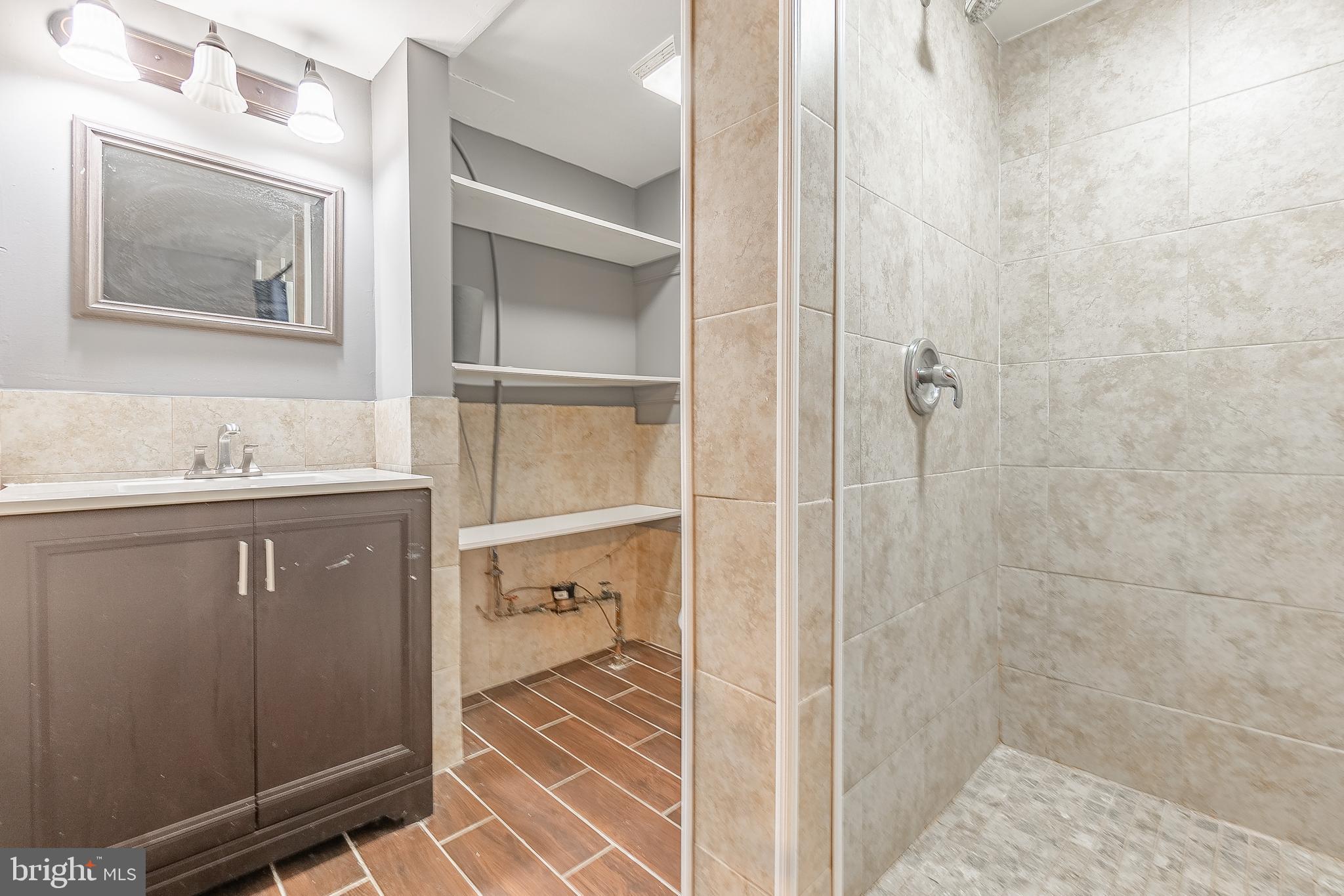 7278 Lamport Road Upper Darby, PA 19082 - Photo 29 of 29 a bathroom with a sink mirror and shower