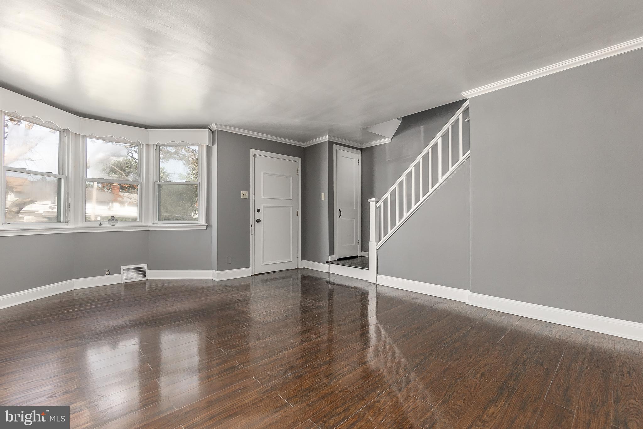 7278 Lamport Road Upper Darby, PA 19082 - Photo 4 of 29 a view of an empty room with wooden floor and a window