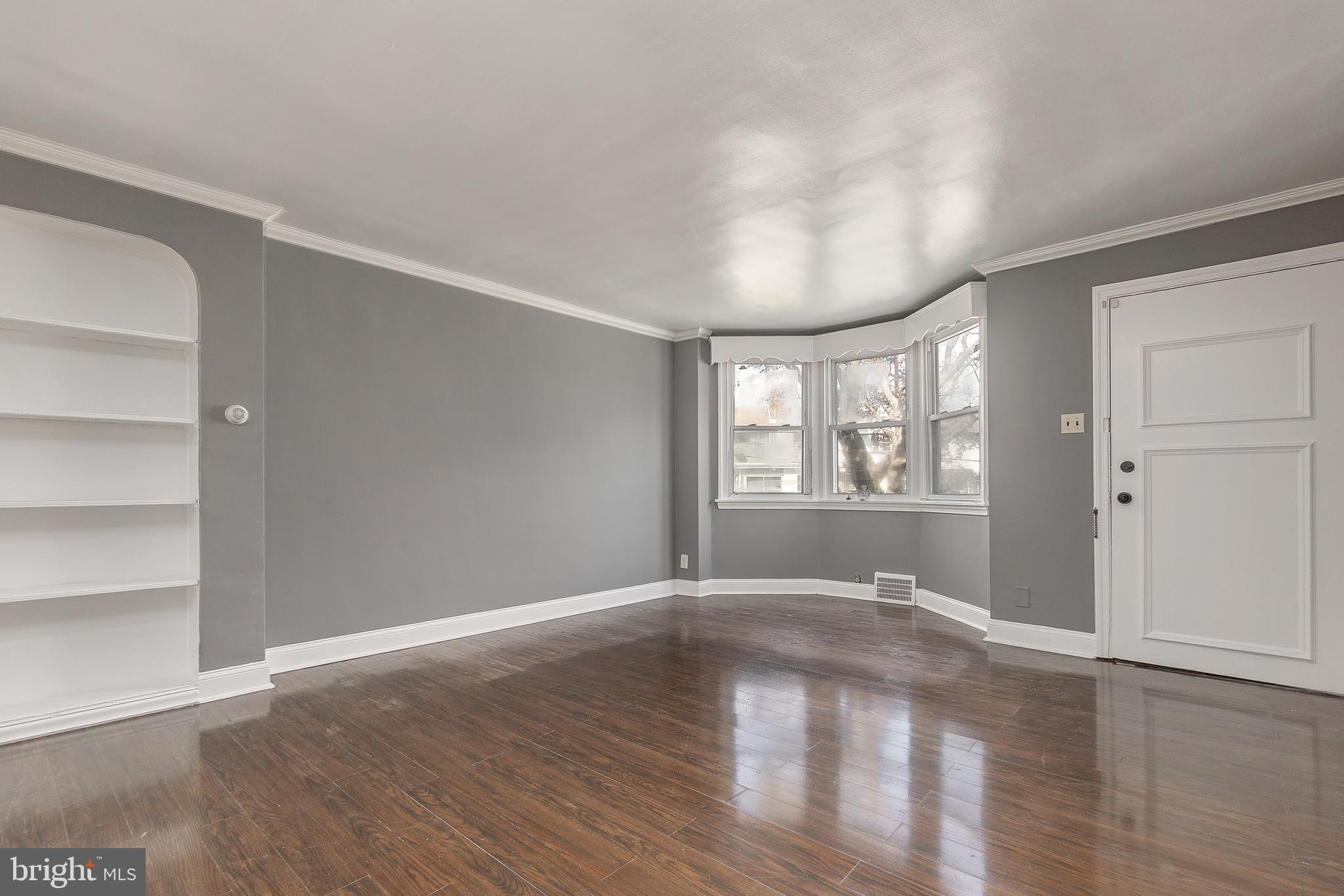 7278 Lamport Road Upper Darby, PA 19082 - Photo 5 of 29 a view of an empty room with window and wooden floor