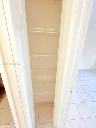 a view of an empty room with large windows