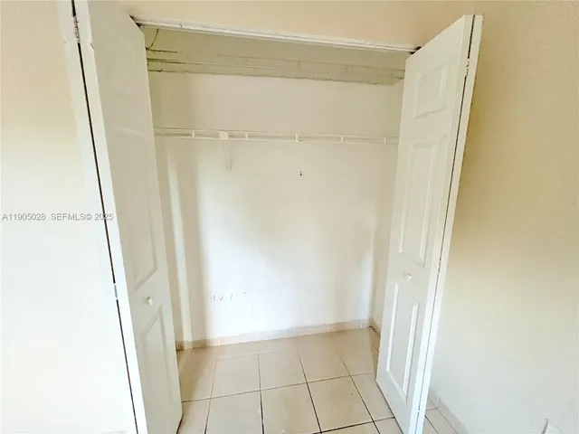 a view of an empty room with closet
