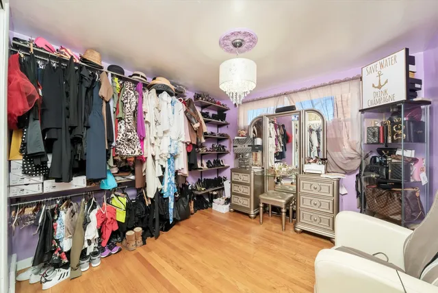 a view of a living room with clothes and a lot of stuff