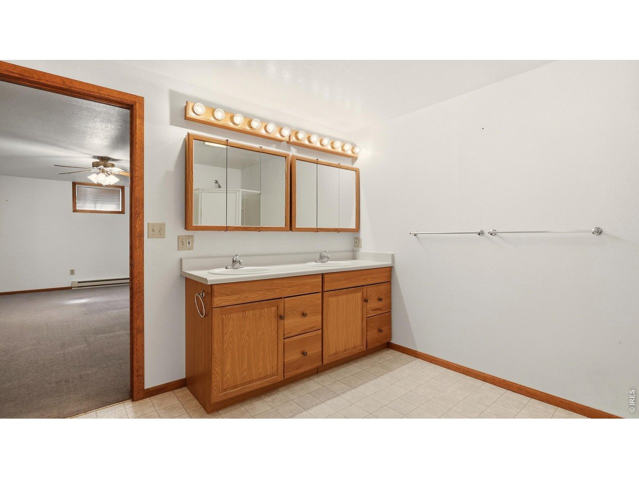 705 Ute Street Fort Morgan, CO 80701 - Photo 23 of 33 a bathroom with a sink double vanity and a mirror