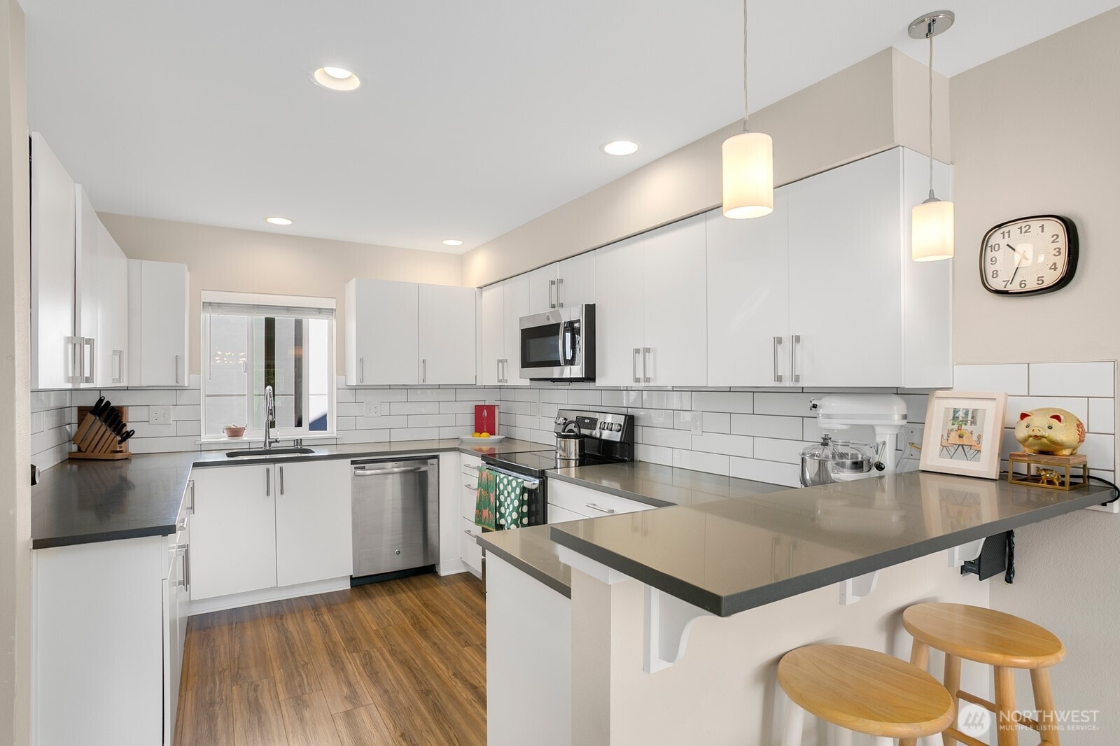 2736 South Andover Street Seattle, WA 98108 - Photo 8 of 24 a kitchen with stainless steel appliances granite countertop a sink dishwasher a stove and a refrigerator with wooden floor