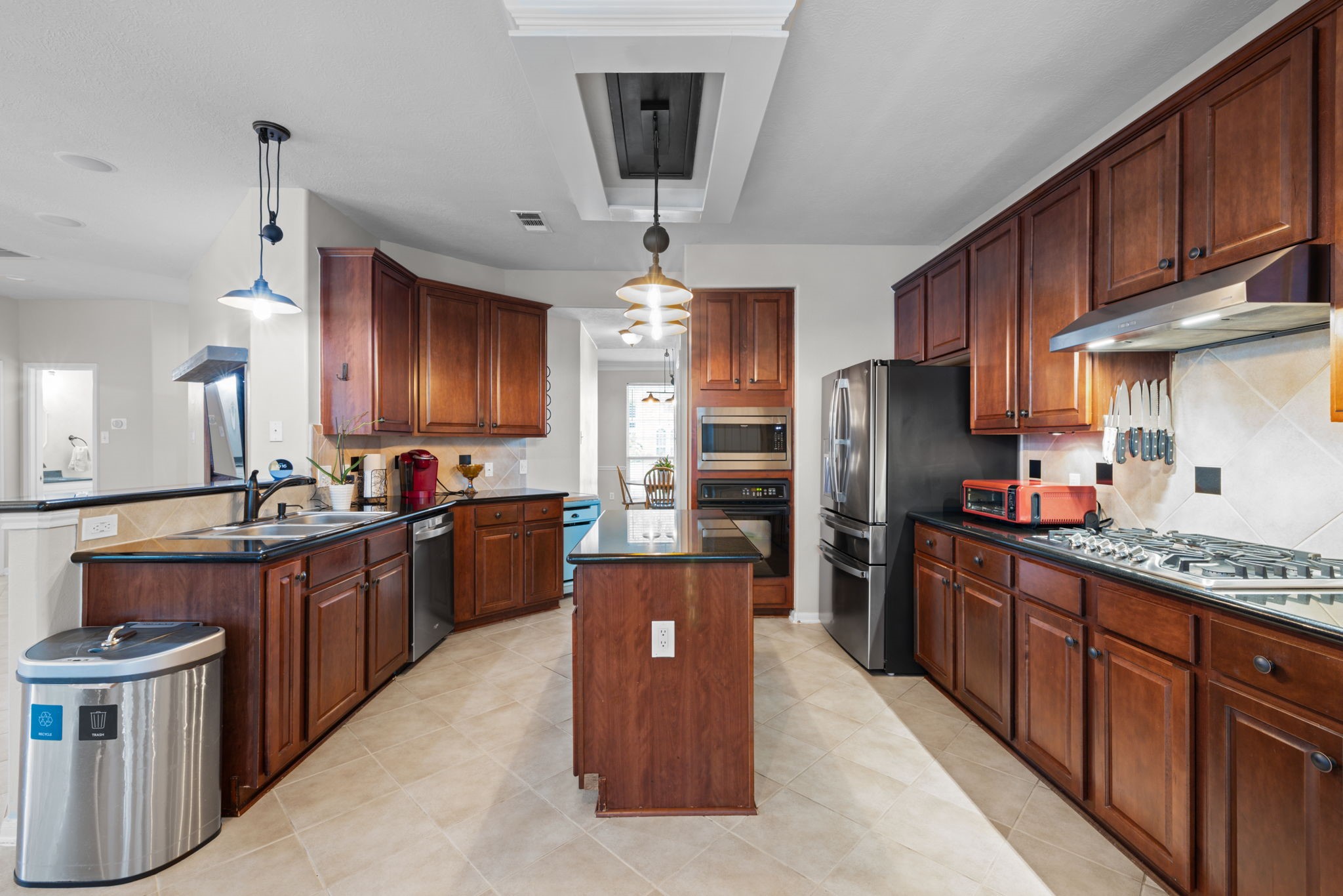19114 Emory Trail Spring, TX 77388 - Photo 14 of 44 a kitchen with stainless steel appliances kitchen island granite countertop a refrigerator stove top oven and sink