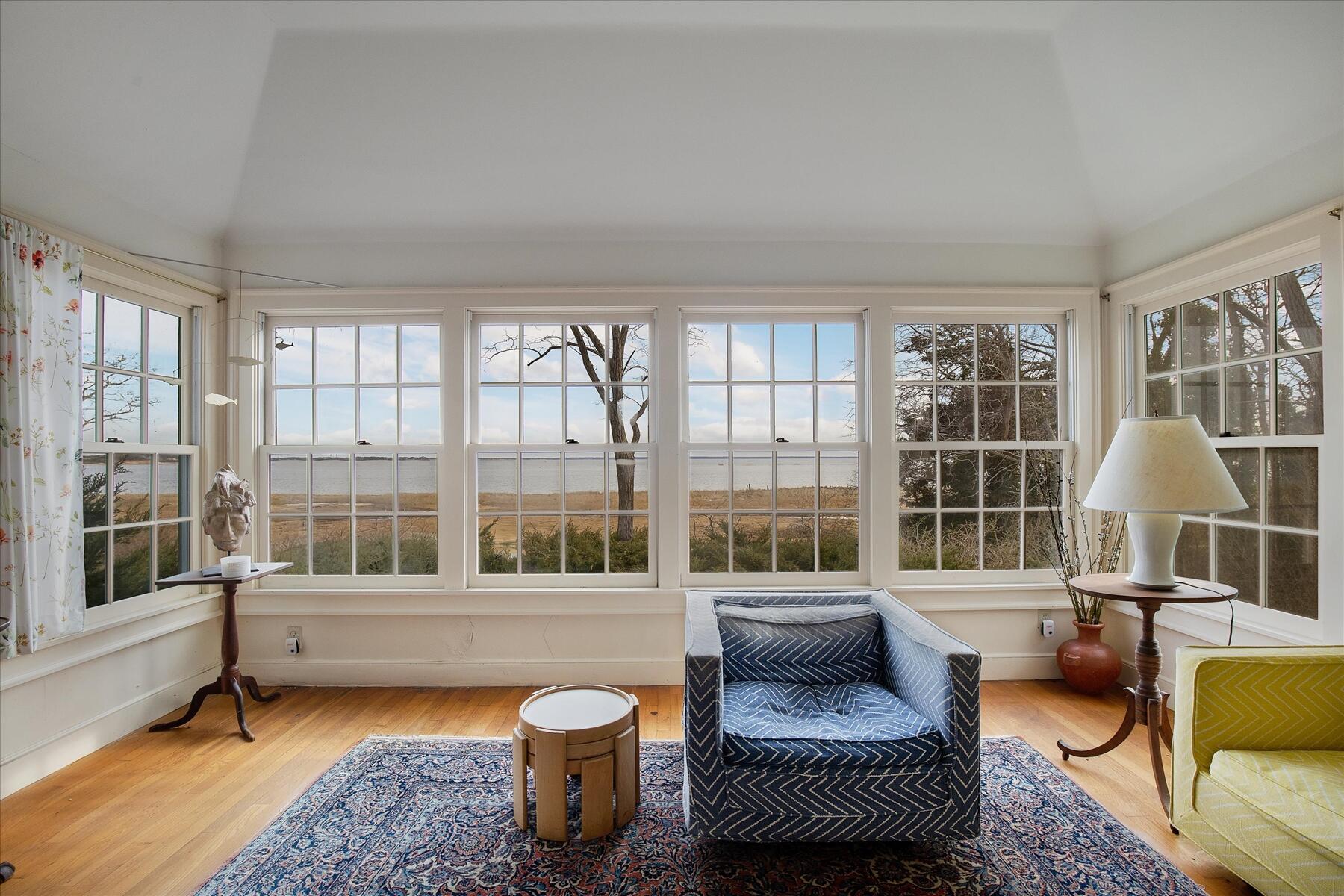 495 Chequessett Neck Road Wellfleet, MA 02667 - Photo 19 of 30 a living room with furniture and a floor to ceiling window