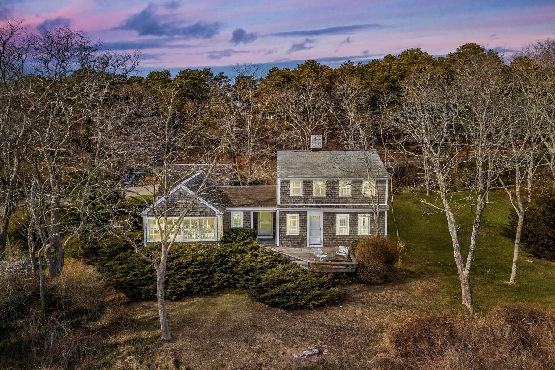 495 Chequessett Neck Road Wellfleet, MA 02667 - Photo 2 of 30 a front view of a house with a yard and mountain view in back