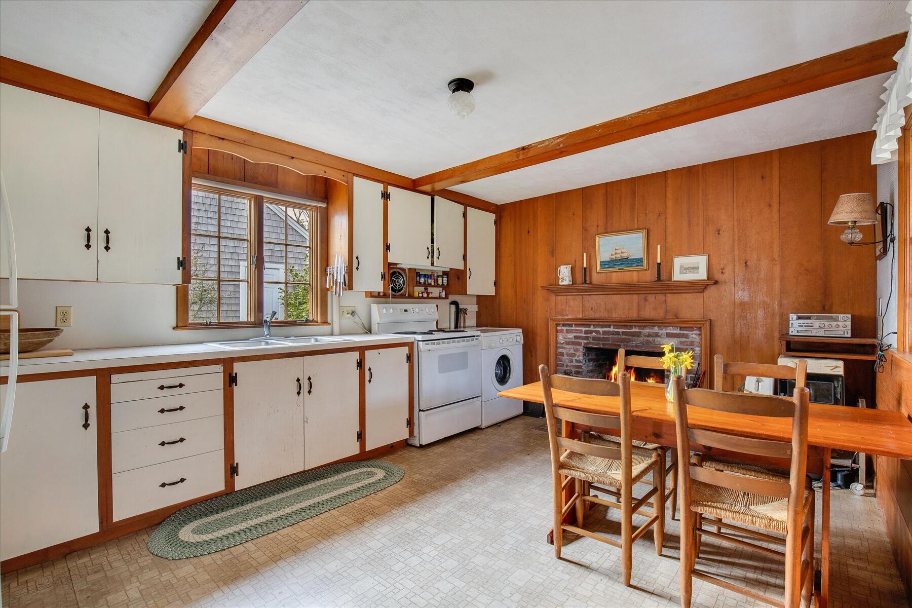 495 Chequessett Neck Road Wellfleet, MA 02667 - Photo 27 of 30 a kitchen with table chairs cabinets and stainless steel appliances