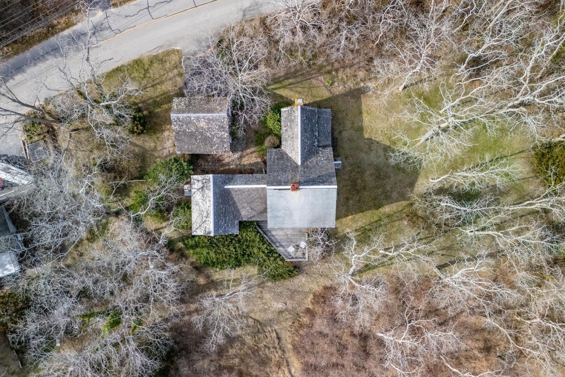 495 Chequessett Neck Road Wellfleet, MA 02667 - Photo 7 of 30 a front view of a house with plants and trees