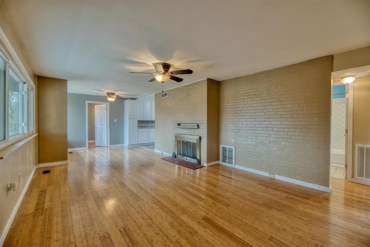 135 Georgia Avenue Oak Ridge, TN 37830 - Photo 5 of 32 a view of a livingroom with a fireplace and wooden floor