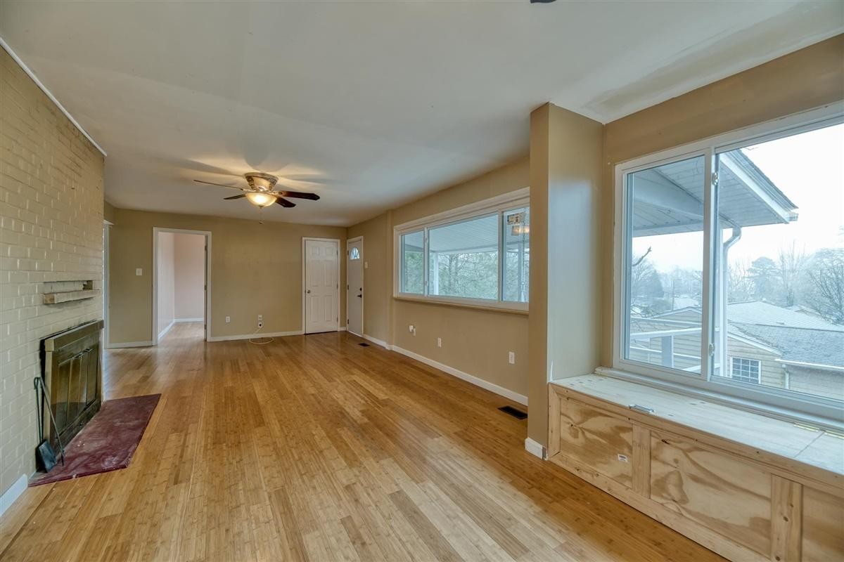 135 Georgia Avenue Oak Ridge, TN 37830 - Photo 6 of 32 a view of an empty room with a window and wooden floor