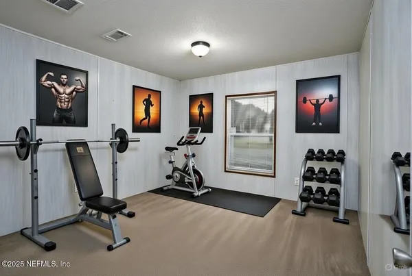 a bedroom that has a bed and a dresser in it