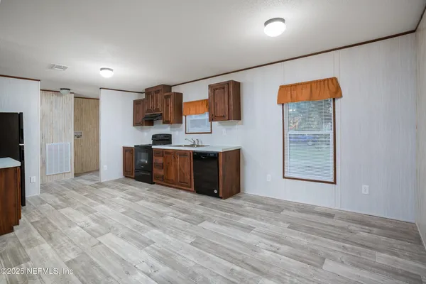 a kitchen with stainless steel appliances granite countertop a stove and a sink
