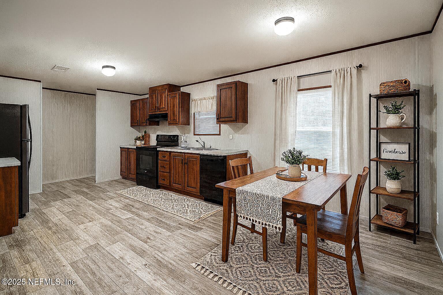 1001 Shell Street Welaka, FL 32193 - Photo 5 of 28 a kitchen with stainless steel appliances granite countertop a stove a refrigerator and a dining table