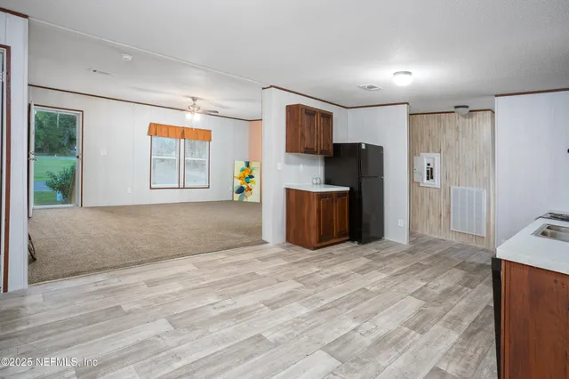 a view of a room with window & ceiling fan