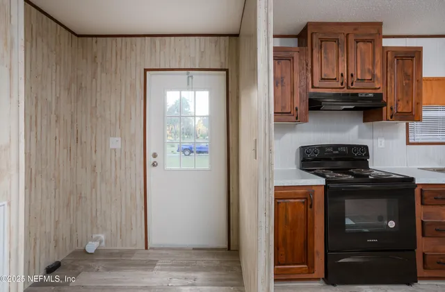 a kitchen with stainless steel appliances granite countertop a stove and a refrigerator