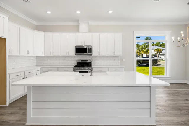 a kitchen with a sink cabinets and window