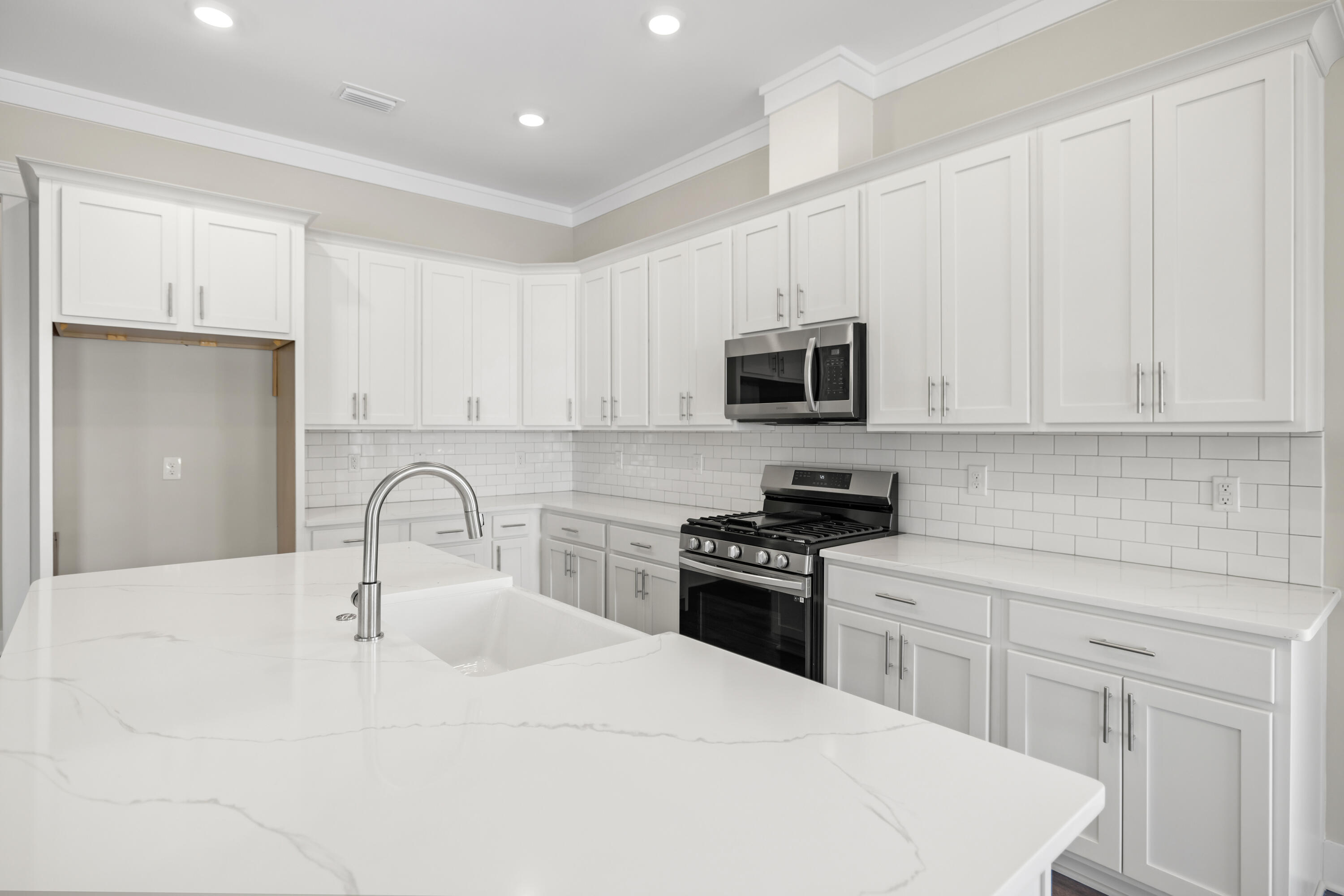 76 Bayou Edge Landing Santa Rosa Beach, FL 32459 - Photo 18 of 49 a kitchen with a sink stove and white cabinets