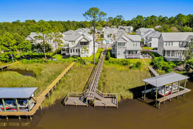 an aerial view of a house with a swimming pool and outdoor seating