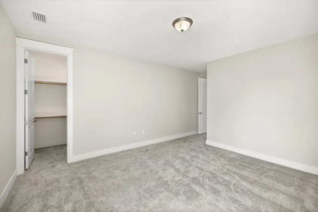 a bathroom with a bathtub shower sink vanity mirror and toilet