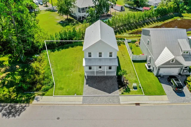 a backyard of a house with table and chairs