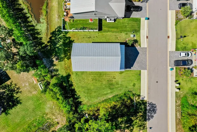 a front view of house with yard and trees around