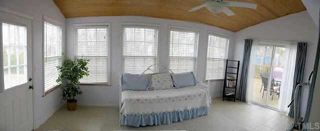 4802 Tapestry Terrace Durham, NC 27713 - Photo 3 of 12 a spacious bedroom with a bed and a potted plant
