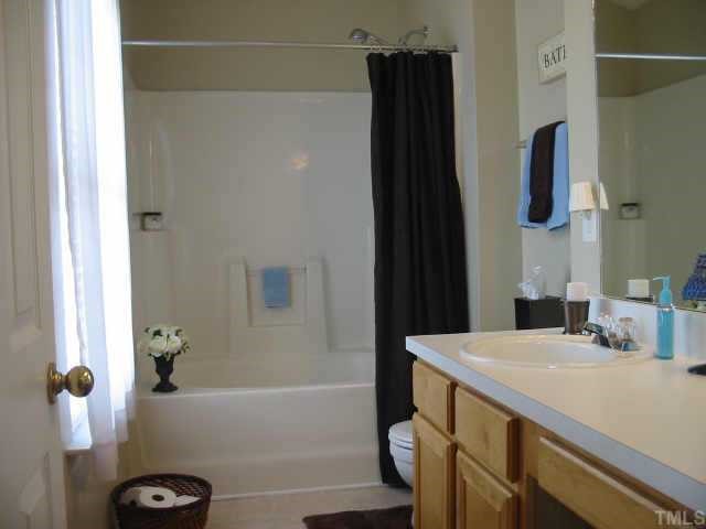4802 Tapestry Terrace Durham, NC 27713 - Photo 9 of 12 a bathroom with a sink and a mirror