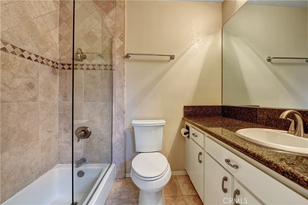 6316 Marina Pacifica Drive North Long Beach, CA 90803 - Photo 18 of 21 a bathroom with a granite countertop sink toilet and shower