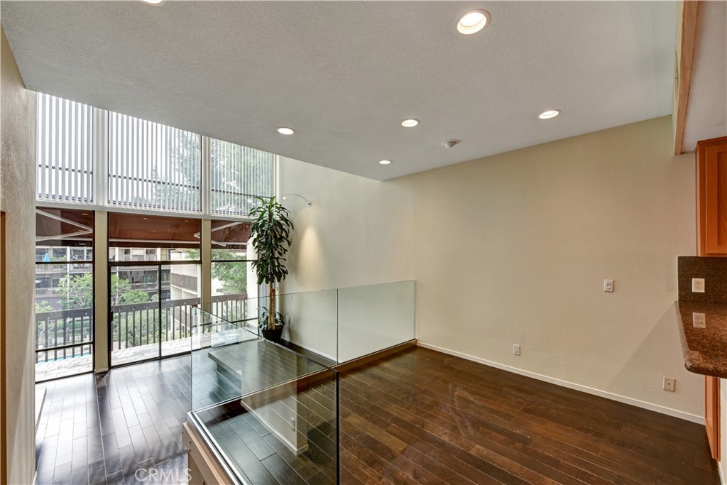 6316 Marina Pacifica Drive North Long Beach, CA 90803 - Photo 3 of 21 an empty room with wooden floor and windows