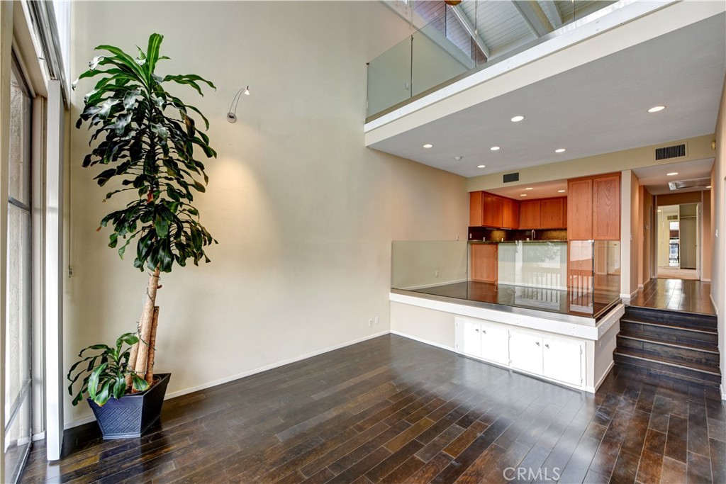 6316 Marina Pacifica Drive North Long Beach, CA 90803 - Photo 5 of 21 a hallway with wooden floor and a potted plant