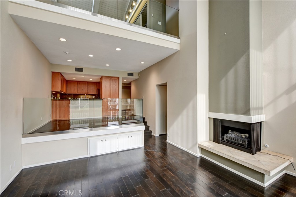 6316 Marina Pacifica Drive North Long Beach, CA 90803 - Photo 6 of 21 a view of kitchen with stainless steel appliances kitchen island wooden cabinets and fireplace