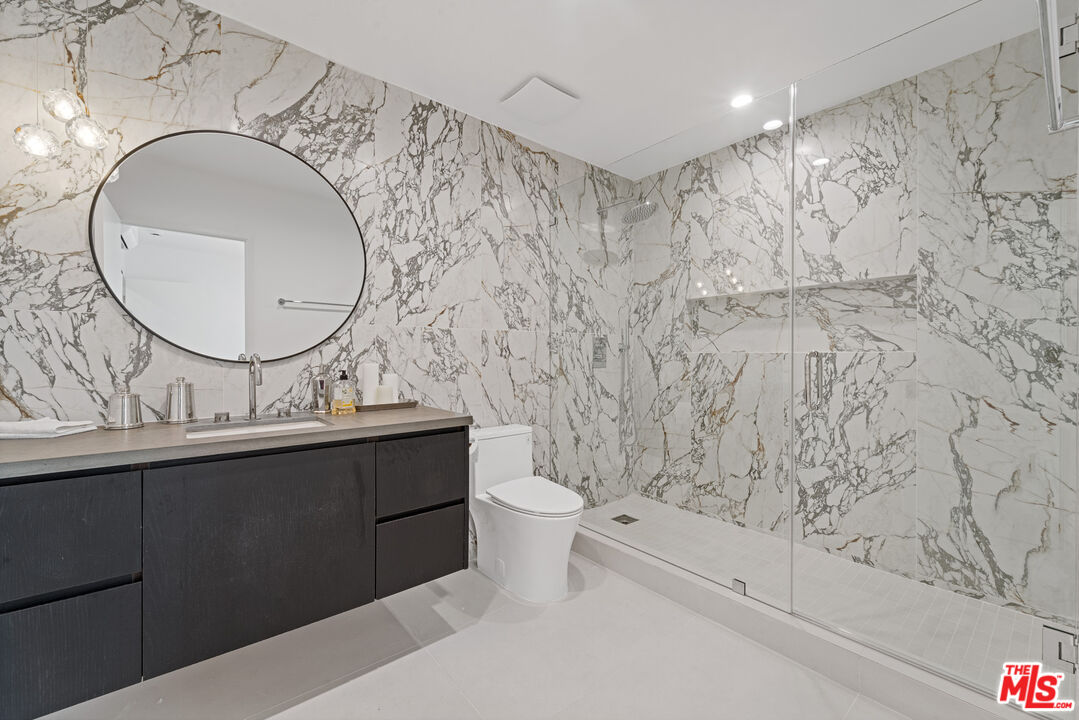 3305 Ocean Front Walk, Unit 2 Marina del Rey, CA 90292 - Photo 12 of 25 a bathroom with a sink a toilet and a mirror