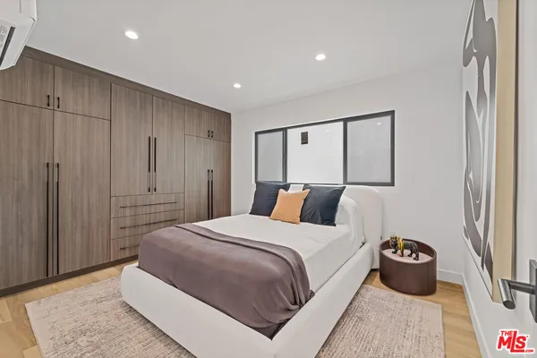 a bedroom with a large bed and a couch