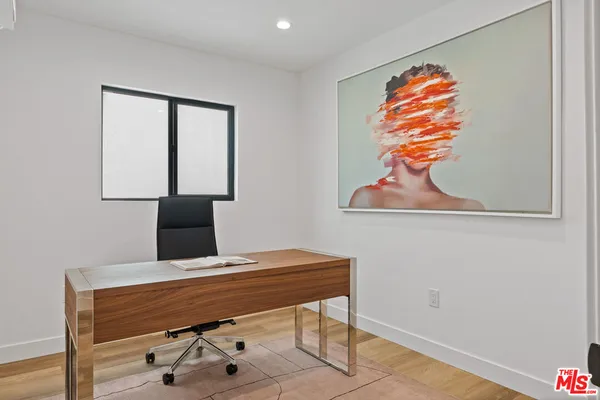 a room with a table and a painting on the wall
