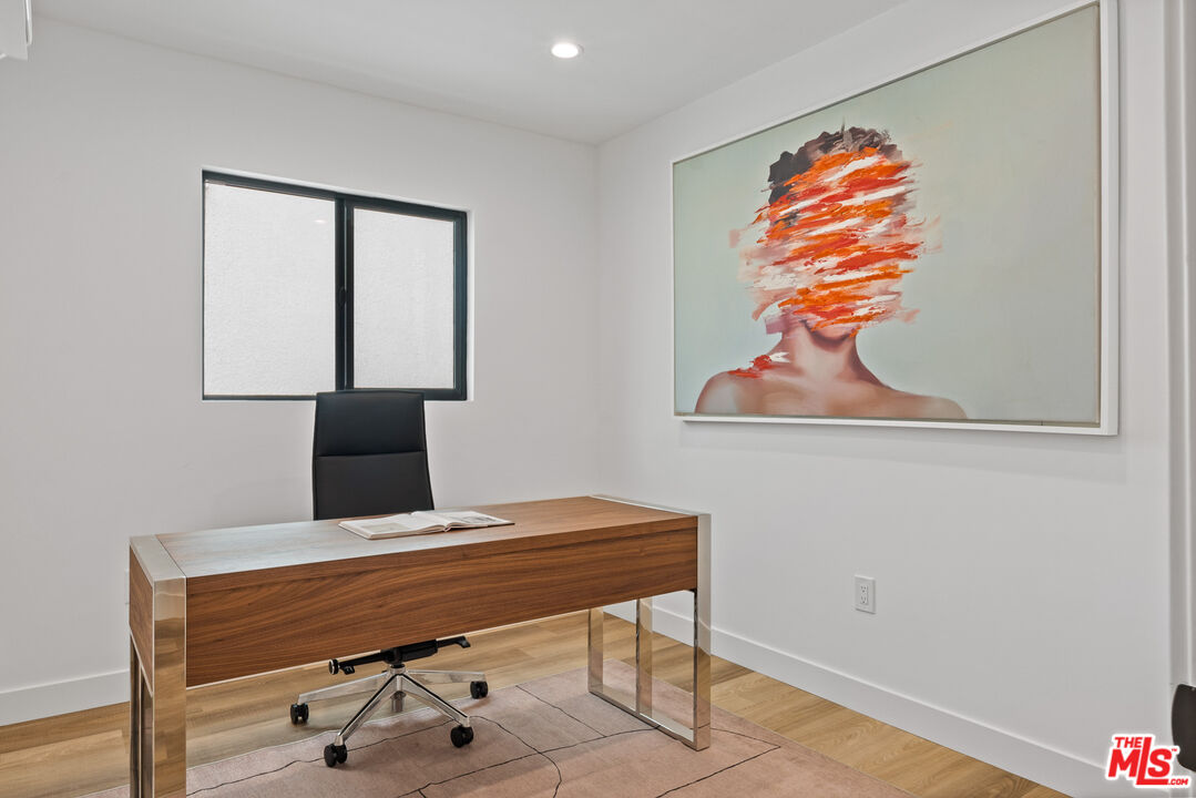 3305 Ocean Front Walk, Unit 2 Marina del Rey, CA 90292 - Photo 20 of 25 a room with a table and a painting on the wall