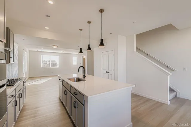 a kitchen with a sink and stove
