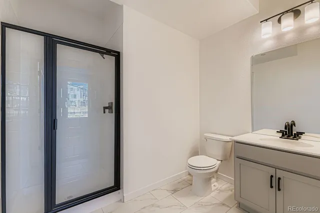 a bathroom with a toilet a sink and a mirror