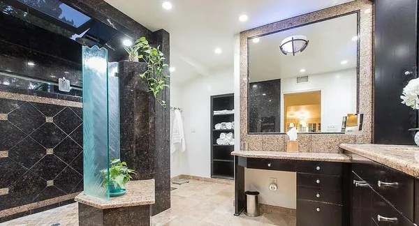 a kitchen with stainless steel appliances granite countertop a stove top oven a sink a dining table and chairs