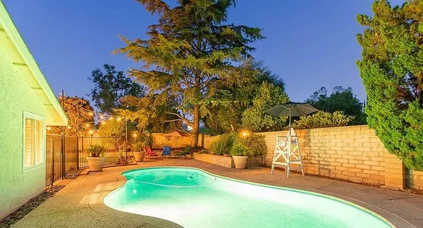 a view of a patio with couches table and chairs and potted plants