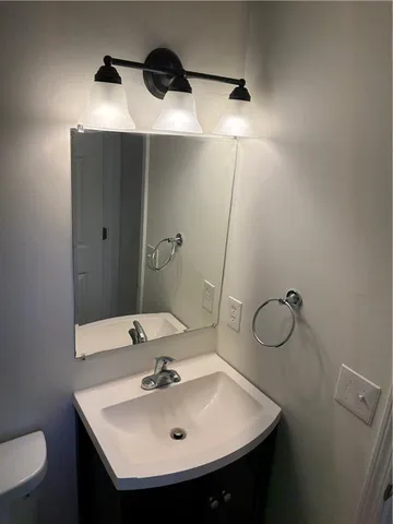 a bathroom with a sink and mirror