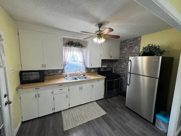a kitchen with a refrigerator a sink and dishwasher
