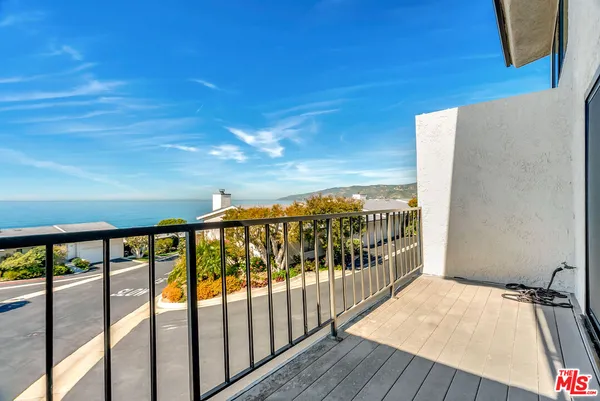a view of a balcony with wooden floor