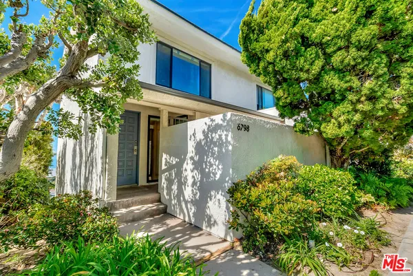 a view of a house with a tree