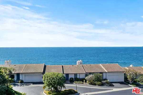 an aerial view of a house with yard