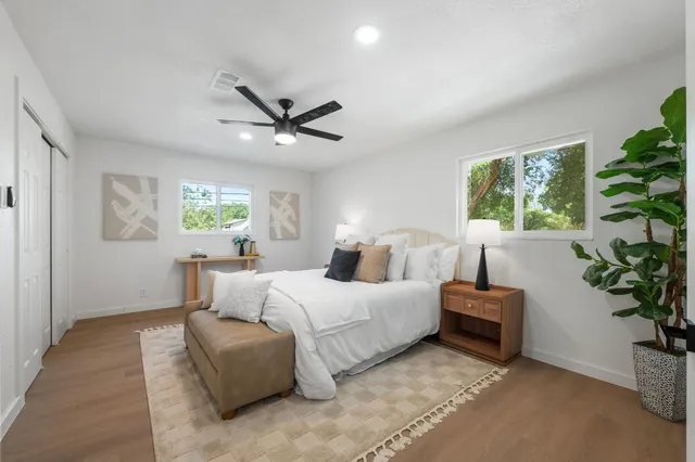 a bedroom with a large bed and a chandelier