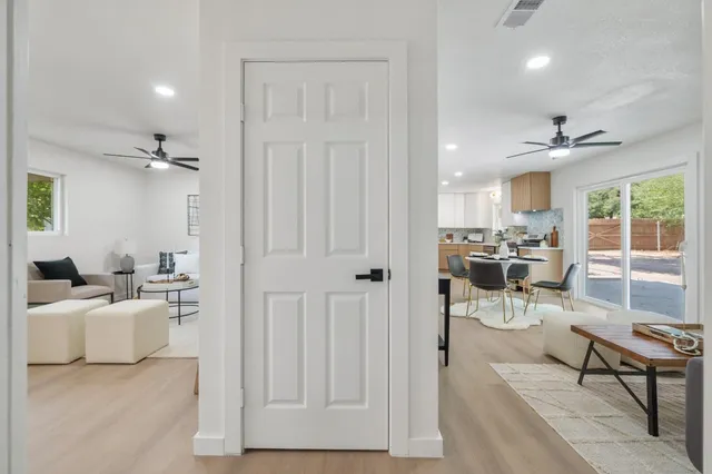 a bedroom with a large bed and a chandelier