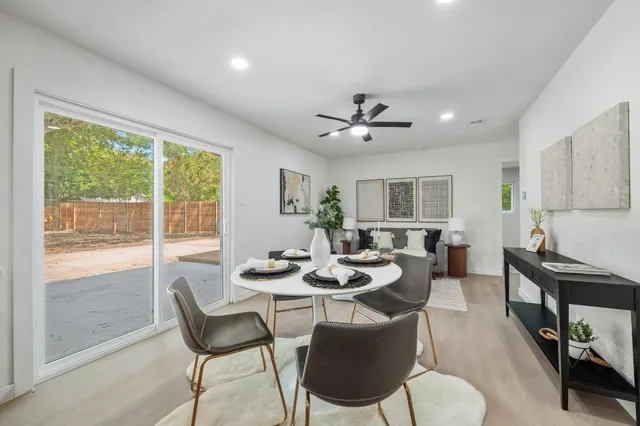 a living room with furniture a rug and a window
