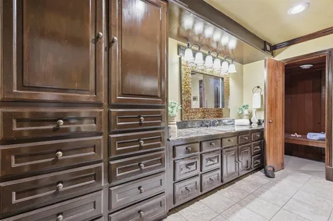 a bathroom with a tub a sink and a mirror